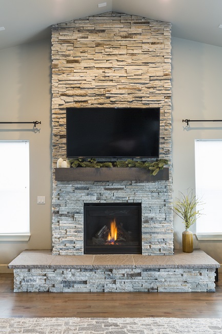 living room with tv over fireplace